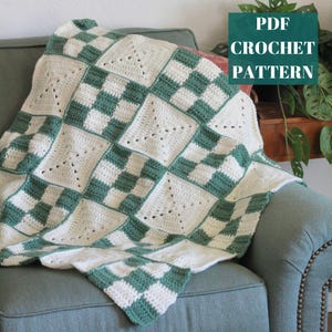 May include: A handmade crochet blanket in a checkerboard pattern of cream and green squares. The blanket is draped over a teal armchair. The text "PDF CROCHET PATTERN" is in a green box in the upper right corner.