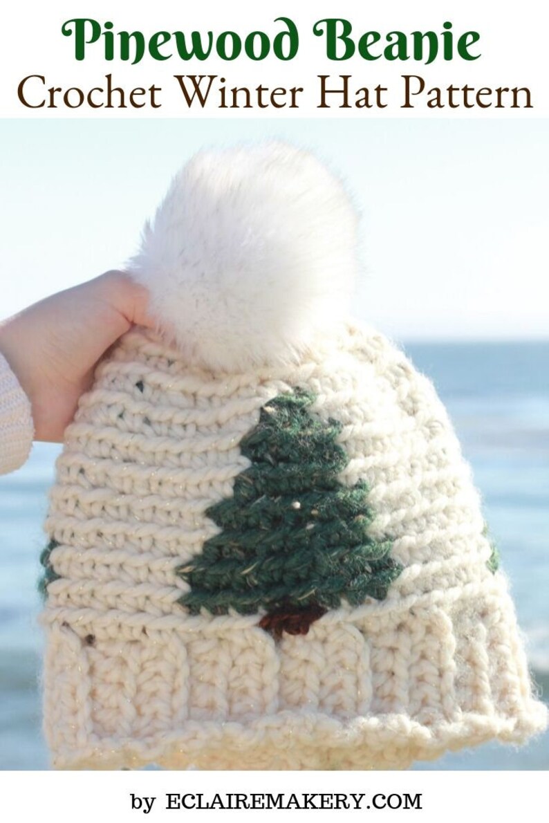 May include: White crochet beanie with a green pine tree design and a white pom pom. The beanie is made with a sparkly yarn. The text "Pinewood Beanie Crochet Winter Hat Pattern by ECLAIReMAKERY.COM" is at the bottom of the image.