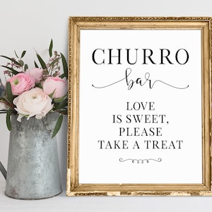 May include: A printable sign with a gold frame that reads "CHURRO bar" in a cursive font. The sign also says "LOVE IS SWEET, PLEASE TAKE A TREAT" in a black sans-serif font.