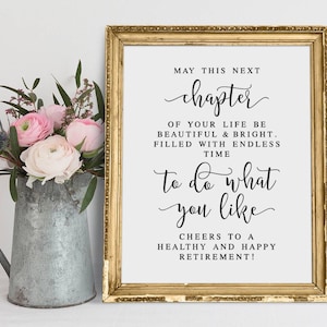 Peut inclure: Une impression encadrée dorée avec un fond blanc et du texte noir qui dit "Que ce prochain chapitre de votre vie soit beau et lumineux. Rempli de temps infini pour faire ce que vous aimez. Santé à une retraite saine et heureuse !"