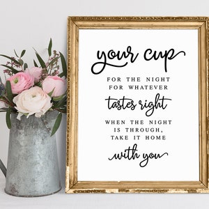 May include: A gold framed sign with the text "your cup" in cursive script. The sign reads "For the night for whatever tastes right. When the night is through, take it home with you."