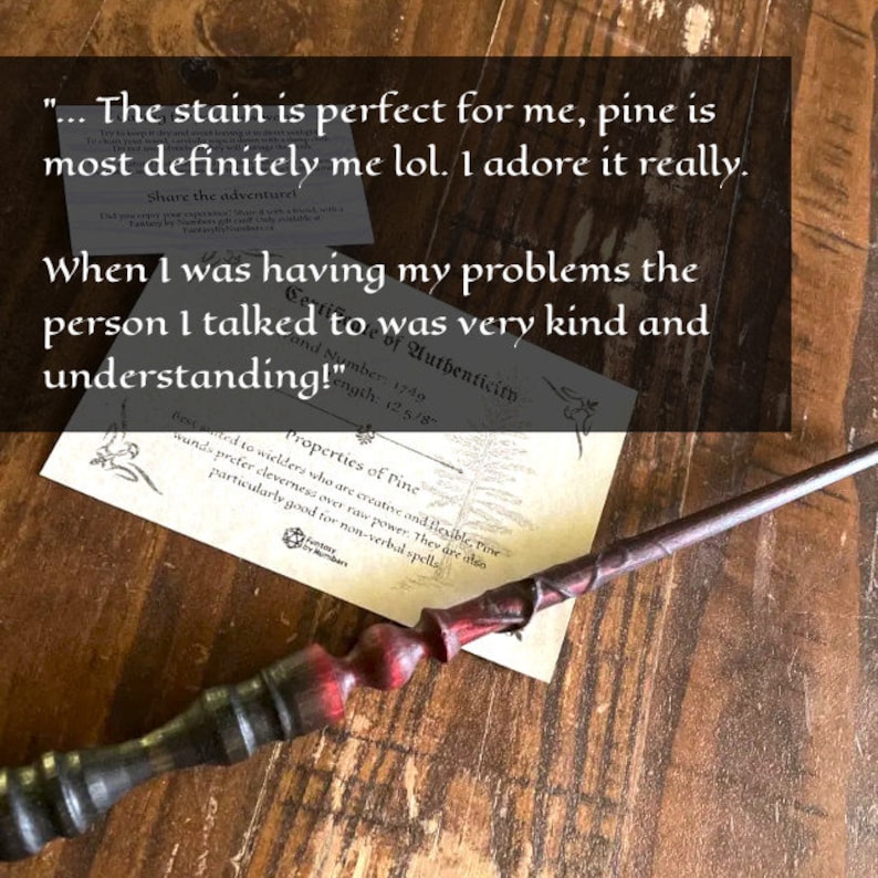 May include: A wooden wand with a dark finish and red accents. The wand has a twisted handle and is lying on a wooden surface. The image also includes a certificate with text about the wand's properties.