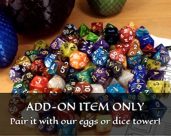 May include: A collection of colorful, multi-sided dice with gold and black accents. The dice are arranged in a pile on a wooden surface. The text "ADD-ON ITEM ONLY Pair it with our eggs or dice tower!" is visible at the bottom of the image.