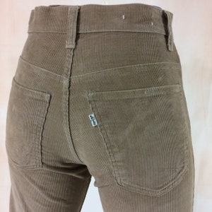 May include: A pair of brown corduroy pants with a Levi's label on the back pocket.