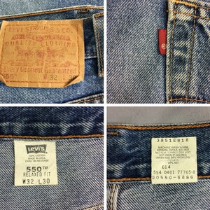 May include: A pair of blue denim jeans with a brown leather Levi's patch and a white Levi's tag. The tag says "550&trade; Relaxed Fit W32 L30". The jeans have a red Levi's tab on the back pocket and a brown leather tag with the text "Levi Strauss & Co. Quality Clothing Every Garment Guaranteed 550 W32 L30".