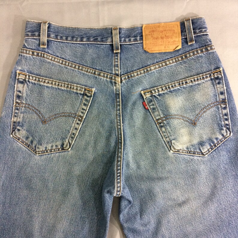 May include: A pair of blue denim jeans with a brown leather patch on the back pocket that says "Levi's&reg;" and "Original  Quality  Clothing  Since 1873".
