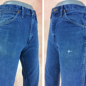 May include: A pair of blue denim jeans with a faded look. The jeans have a classic five-pocket style and a straight leg.