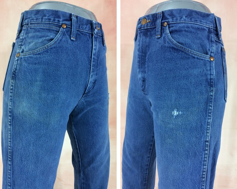 May include: A pair of blue denim jeans with a faded look. The jeans have a classic five-pocket style and a straight leg.