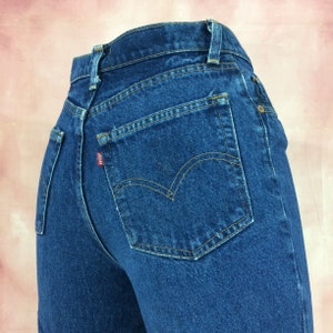 May include: A pair of blue denim jeans with a back pocket and a red Levi's tab.