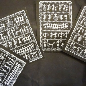 May include: Four black and white art prints with a white border. The prints feature traditional Indian folk art with white figures and animals on a black background.
