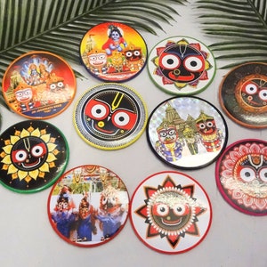 May include: A set of 10 round coasters featuring colorful images of Hindu deities. The coasters are made of wood and have a glossy finish. The images include a deity with multiple eyes, a deity with a crown, and a deity with a flower garland.