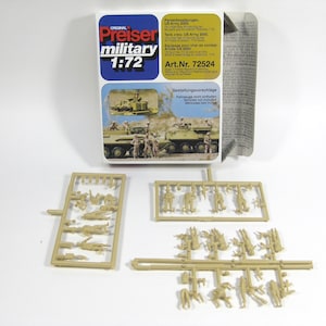 May include: A plastic model kit of US Army soldiers in 1:72 scale. The kit includes a box with instructions and two sprues of plastic figures. The box has the text "ORIGINAL Preiser military 1:72 Art.Nr. 72524" on it.