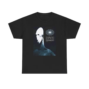 May include: Black t-shirt with a graphic of a white face and a circular design. The text on the shirt reads "If you can't see it, it doesn't exist. If you can't feel it, it's not real. If you can't hear it, it's not there. If you can't smell it, it's not true. If you can't taste it, it's not alive. If you can't touch it, it's not yours. If you can't understand it, it's not important. If you can't explain it, it's not worth knowing. If you can't believe it, it's not real. If you can't love it, it's not worth having. If you can't let go of it, it's not yours to keep."