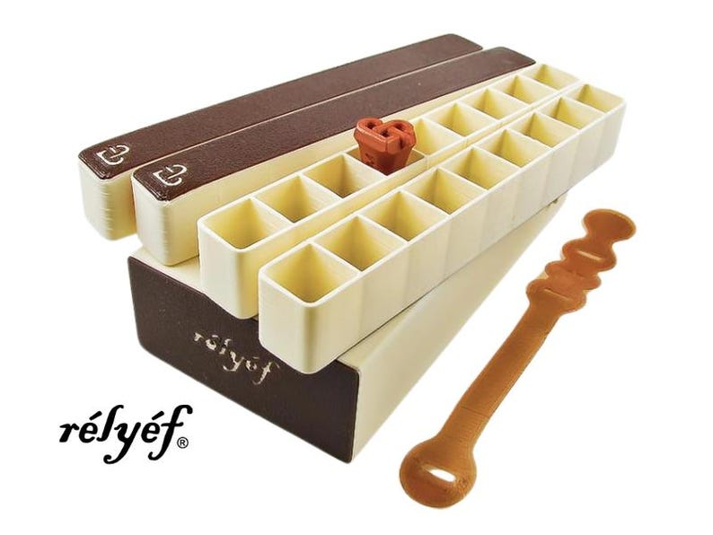 May include: A white and brown plastic storage box with a removable lid and a brown label that says "r&eacute;ly&eacute;f". The box has 24 compartments and is designed to hold small items. A brown plastic tool is also included.