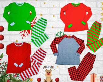 May include: Four sets of matching Christmas pajamas. Each set includes a long-sleeved top and pants. The tops are red, green, gray, and red. The pants are red and white striped, green and white striped, red and black plaid, and red and green striped.