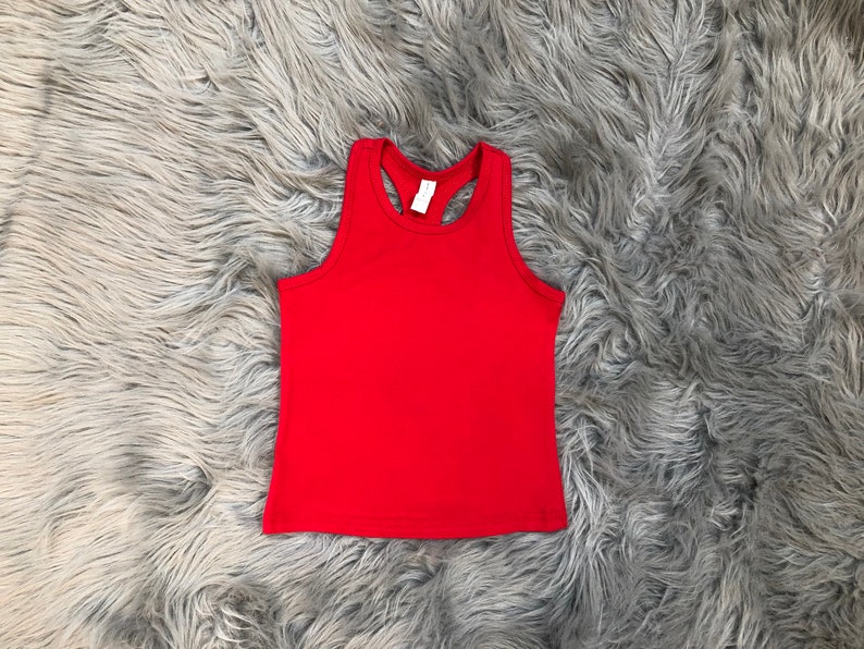 May include: A red sleeveless tank top with a racerback style.