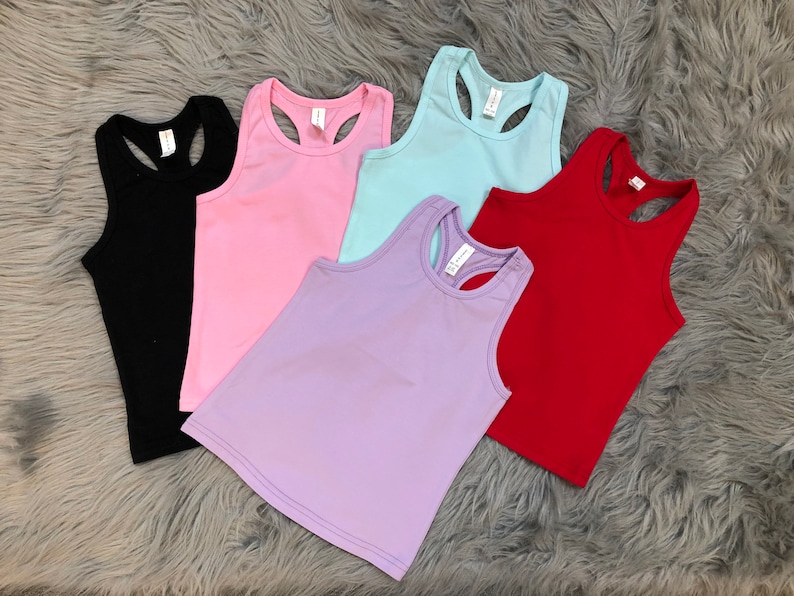 May include: Five sleeveless shirts in different colors: black, pink, light blue, lavender, and red. The shirts have a racerback style.