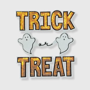 May include: A Halloween-themed decoration with the words "TRICK" and "TREAT" in gold sequins. Two white ghost figures are connected by a thin line with the word "or" in between. The design is on a white background.