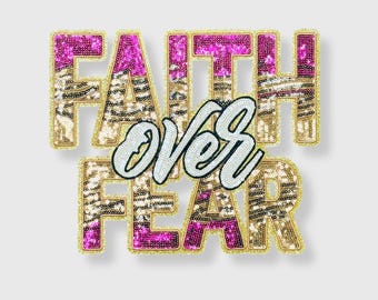 May include: A decorative sequined patch with the words "FAITH OVER FEAR". The letters are outlined in gold and filled with pink and gold sequins. The word "OVER" is in white cursive script.
