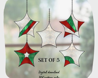 May include: Set of five stained glass star ornaments with red, green, and white designs. The ornaments are hanging from chains and have a white background. The text "SET OF 5" is printed below the ornaments. The text "Digital download PDF pattern only" is printed below the text "SET OF 5".