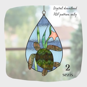 May include: A stained glass pattern of a sea turtle in a teardrop shape with a blue background, green seaweed, and a pink flower. The pattern is labeled "2 sezis" and is a digital download PDF pattern only.