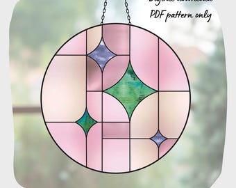 May include: A stained glass window pattern featuring a circular design with pink, green, and blue geometric shapes. The pattern is for a digital download, PDF pattern only.
