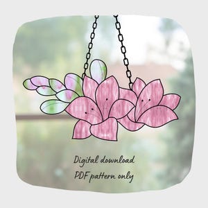 May include: A digital download PDF pattern for a stained glass hanging featuring pink flowers with green leaves and a black chain.