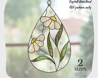 May include: A stained glass pattern of a teardrop-shaped window hanging with two white flowers and green leaves. The pattern is available in two sizes. Digital download PDF pattern only.