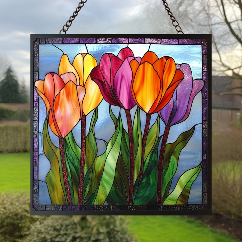 May include: A stained glass window panel featuring a colorful bouquet of five tulips in shades of orange, yellow, pink, and purple. The tulips are arranged in a vase with green leaves and stems. The background is a light blue sky.