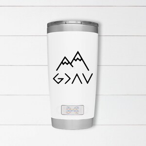 May include: White stainless steel tumbler with a black mountain range graphic and the text "G>A>V" in black.