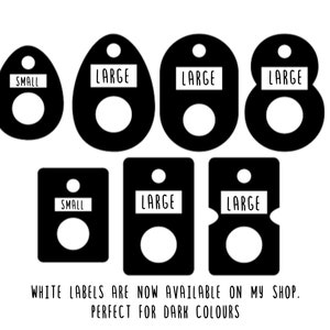 May include: Black labels in various shapes, each with a white center circle and a small white rectangle at the top. The rectangles read "SMALL" or "LARGE". Text at the bottom says "WHITE LABELS ARE NOW AVAILABLE ON MY SHOP. PERFECT FOR DARK COLOURS."