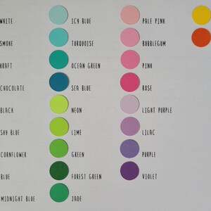 May include: A color chart featuring circular swatches in various hues, including white, black, blue, pink, and green. Each color is labeled with its name, such as "Sky Blue," "Rose," and "Sunshine." The chart is arranged on a white background.