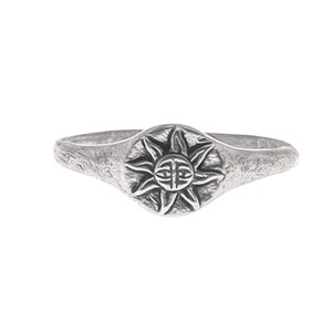 Könnte beinhalten: Ein silberfarbener Ring mit einem detaillierten Sonnenstrahl-Design auf einer kreisförmigen Oberfläche. Der Ring hat ein strukturiertes Band und ein leicht verwittertes Aussehen, das auf einen Vintage-Stil hindeutet. Das Sonnenstrahl-Design hat komplizierte Details.