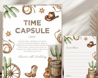 May include: A time capsule set with a cowboy theme. The main sign reads "TIME CAPSULE" and "2042". Decorative elements include a cowboy hat, cactus, rope, and a guitar. A smaller card is included with the text "Dear Oliver".