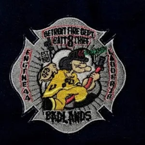 May include: A gray and red embroidered patch with a cartoon firefighter holding a hose. The patch says "Detroit Fire Dept. Batt. 8 Chief Engine 44 Ladder 78  Brdlands" and "Est. 1900".