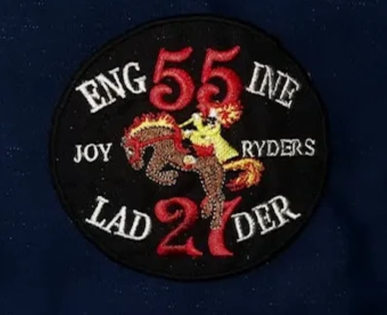 May include: Black and white embroidered patch with red and yellow accents. The patch reads "ENG 55 INE JOY RYDERS LAD 21 DER".