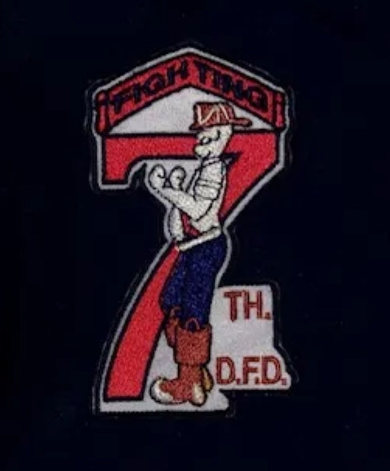 May include: A red and white embroidered patch with a cartoon firefighter holding a hose. The patch says "Fighting 7th D.F.D."