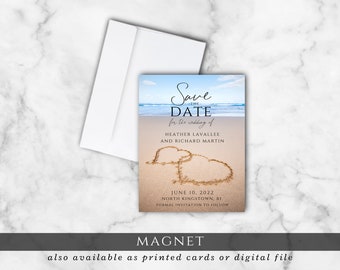 May include: A save-the-date magnet featuring a beach scene with the text "Save the Date" and wedding details. The design includes two hearts drawn in the sand, with the names Heather Lavallee and Richard Martin, and the date June 10, 2022.