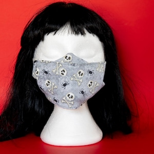 Maschera per il viso non medico in cotone. Le caratteristiche si piegano il naso e il lembo del mento.
