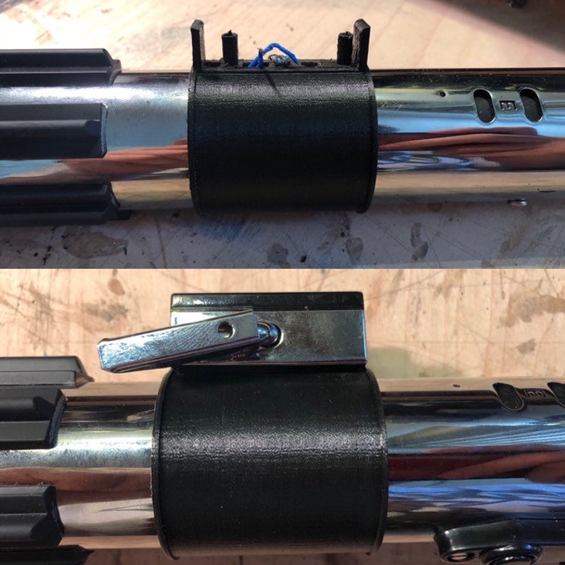 May include: A black 3D printed lightsaber hilt extension with a silver metal switch. The extension is attached to a silver lightsaber hilt.