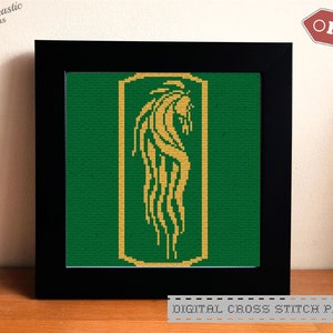 May include: A framed cross stitch pattern featuring a gold-colored creature with a long, flowing tail on a green background. The pattern is titled "Digital Cross Stitch Pattern".