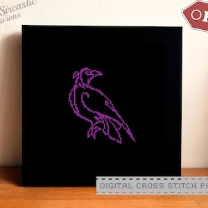 May include: Digital cross stitch pattern featuring a purple crow on a black background. The pattern is available as a PDF download.