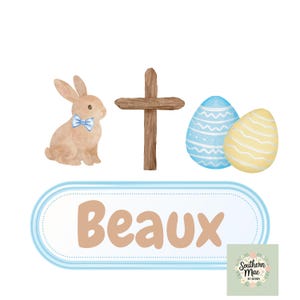 Op de afbeelding: Waterverfillustratie met een Pasen-thema. Een bruin konijn met een blauwe vlinderdas, een houten kruis en twee versierde eieren in blauw en geel worden getoond. De naam "Beaux" is in lichtbruine letters geschreven in een blauw omrand ovaal.