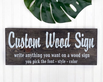 May include: A brown wooden sign with white text that reads "Custom Wood Sign" and "write anything you want on a wood sign you pick the font - style - color".