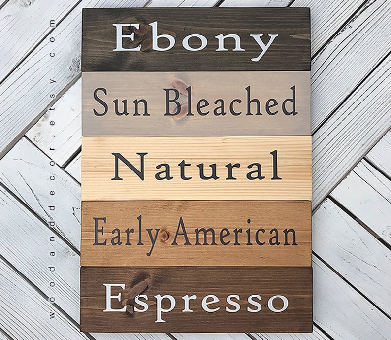 May include: Five wooden boards stained in different shades of brown. The boards are labeled "Ebony", "Sun Bleached", "Natural", "Early American", and "Espresso".