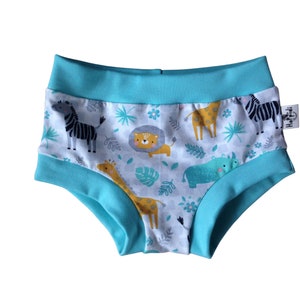 May include: Turquoise blue underwear with a white background and a print of various jungle animals, including zebras, giraffes, lions, and a rhinoceros. The underwear has a turquoise blue waistband and a small label with the word "Hopidi" on the right side.