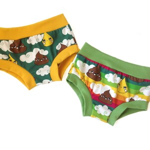 May include: Two pairs of underwear with a green and yellow background. The underwear has a print of brown poop with a face and a yellow raindrop with a face. One pair has a rainbow stripe pattern.