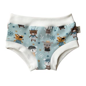 May include: Light blue underwear with a white waistband and a pattern of cartoon animals wearing sailor hats and holding anchors. The animals include a bear, a cat, a dog, and a rabbit.