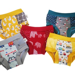 May include: Five pairs of colorful underwear with different patterns. The patterns include seagulls, elephants, construction vehicles, and a fire truck.