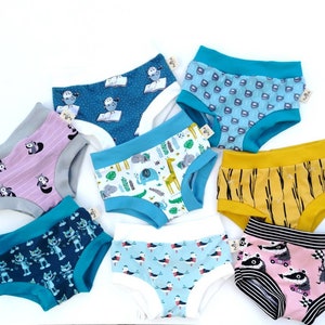 May include: Assortment of colourful underwear with various patterns, including owls, animals, and geometric designs. The underwear is made of soft, comfortable fabric and features a variety of colours, including blue, pink, yellow, and green.